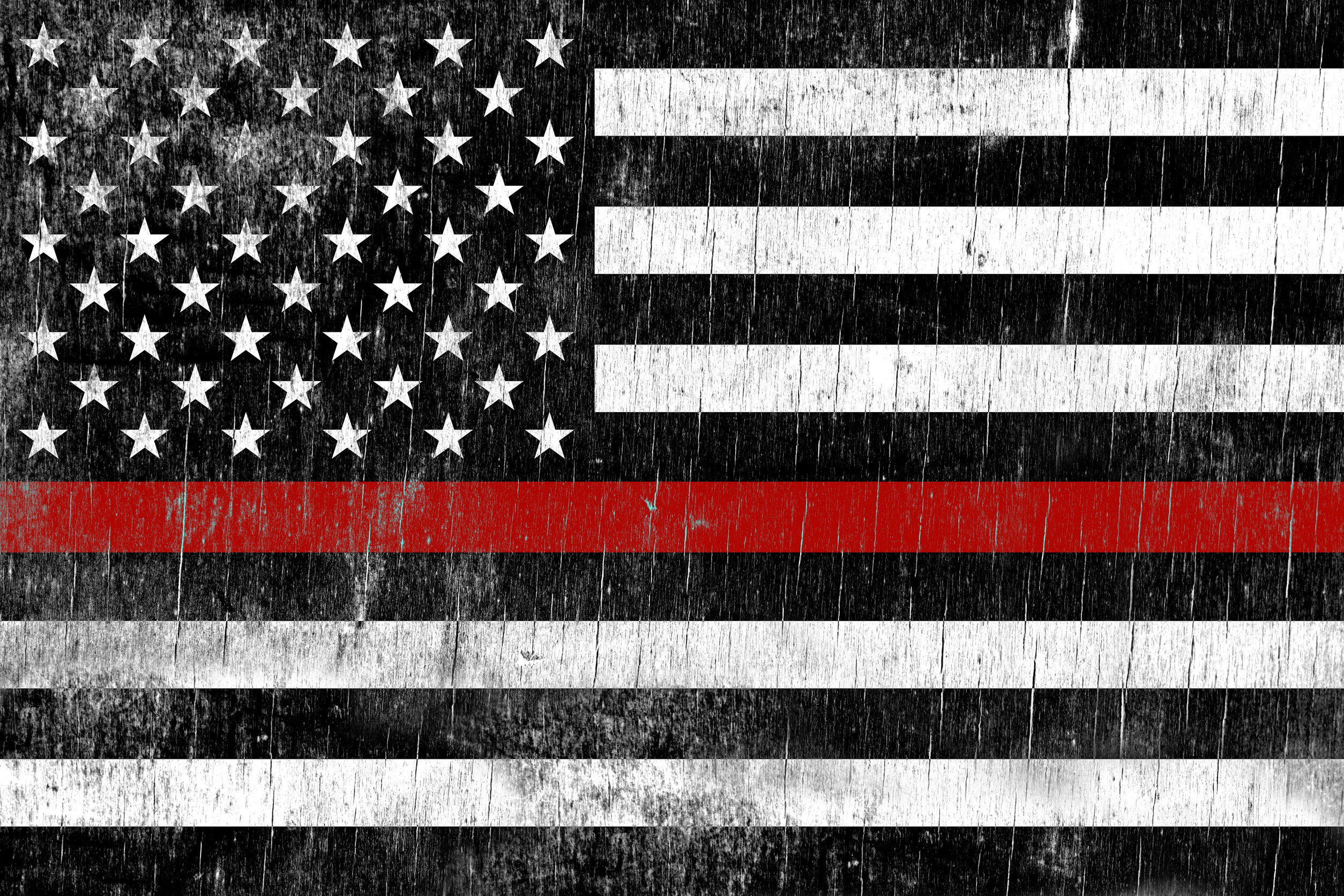A firefighter support flag painted over a cracking wooden texture.